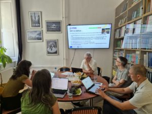Several individuals gathered at a table, focused on their laptops while sharing ideas and collaborating on projects.