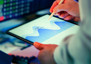 Person exploring data visualisations on a tablet, representing interactive analysis of educational inequalities and policy indicators